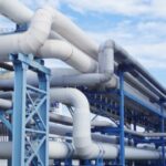 A closeup of industrial pipelines around a factor on a sunny day